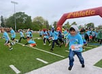 Kids take off from the starting line at the annual Awesome 3000 youth fun run in Salem, Ore., on April 27, 2024. More than 2,000 kids participated this year.