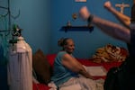 August 20, 2020 - Dr. Gustavo Gutierrez checks on Marta Navarro Morales, 63, in her home in Matamoros. He gesticulates wildly as he reminds her to exercise her arms so that she doesn't lose muscle laying in bed. Navarro survived breast cancer, and Dr. Gutierrez says her covid19 case, which began nearly a month ago, has improved drastically. Her makes her smile, calling her a VIP patient. 
Dr. Gustavo Gutierrez, an emergency medicine doctor living in Reynosa, Tamaulipas, is treating covid19 patients in their homes (as well as the hospitals he works in) as the pandemic rages on along the border towns in Tamaulipas. His phone never stops ringing or buzzing, and he sometimes goes 24 hours without sleep juggling his time visiting patients at home and his shifts at the hospitals. Having already battled covid himself, he brings his personal experience along with his medical expertise in to his treatment of patients, many of whom are afraid of going to the hospital. 
Meghan Dhaliwal for The New York Times 