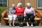 From left Coquille Indian Tribe citizens, Joyce Blake, Jean Moore and Judy Rocha sit on a bench outside The Mill Casino Hotel in North Bend, Oregon. The three sisters gathered with their families the last weekend in June to celebrate the 35th Annual Restoration Celebration for the Coquille Indian Tribe.