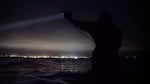 From their small inflatable boat, the capture team scans for murrelets floating on the open ocean.