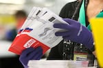 An election worker sorts vote-by-mail ballots for the presidential primary at King County Elections in Renton, Wash., in March 2020.