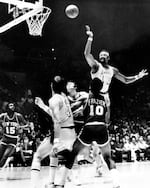 FILE - In this April 30, 1972, file photo, Los Angeles Lakers' Wilt Chamberlain (13) fires a leaping scoop shot against the New York Knicks in an NBA Finals basketball game in Los Angeles.