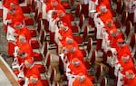 Three rows of cardinals dressed in red and white look on as the body of Pope Francis is transferred into the Basilica at St Peter’s Square in Vatican City on Wednesday.