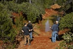 A Homeland Nickel team stands near a trench dug by a previous mining company at their Red Flat claim in Curry County in June of 2026.