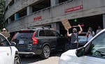 A protester yells at an arriving attendee of the annual Portland Metro Chamber meeting at the Moda Center. The Rally Against Moda Madness was a community picket and picnic held at the Moda Center in Portland, Ore., on June 24, 2026.