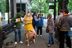 J. Schuberth, who is running for Oregon governor as “Pencil” and dresses the part, speaks with voters and curious passersby as they walk around downtown Portland, Ore., to campaign on April 23, 2026. Schuberth is hoping to raise awareness about Oregon’s dead last 4th grade literacy ranking among other U.S. states and is an advocate for reforming the state’s K-12 school system.