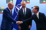 Turkish President Tayyip Erdogan (left) and Swedish Prime Minister Ulf Kristersson shake hands in front of NATO Secretary-General Jens Stoltenberg prior to their meeting, on the eve of a NATO summit, in Vilnius, Lithuania, on Monday.