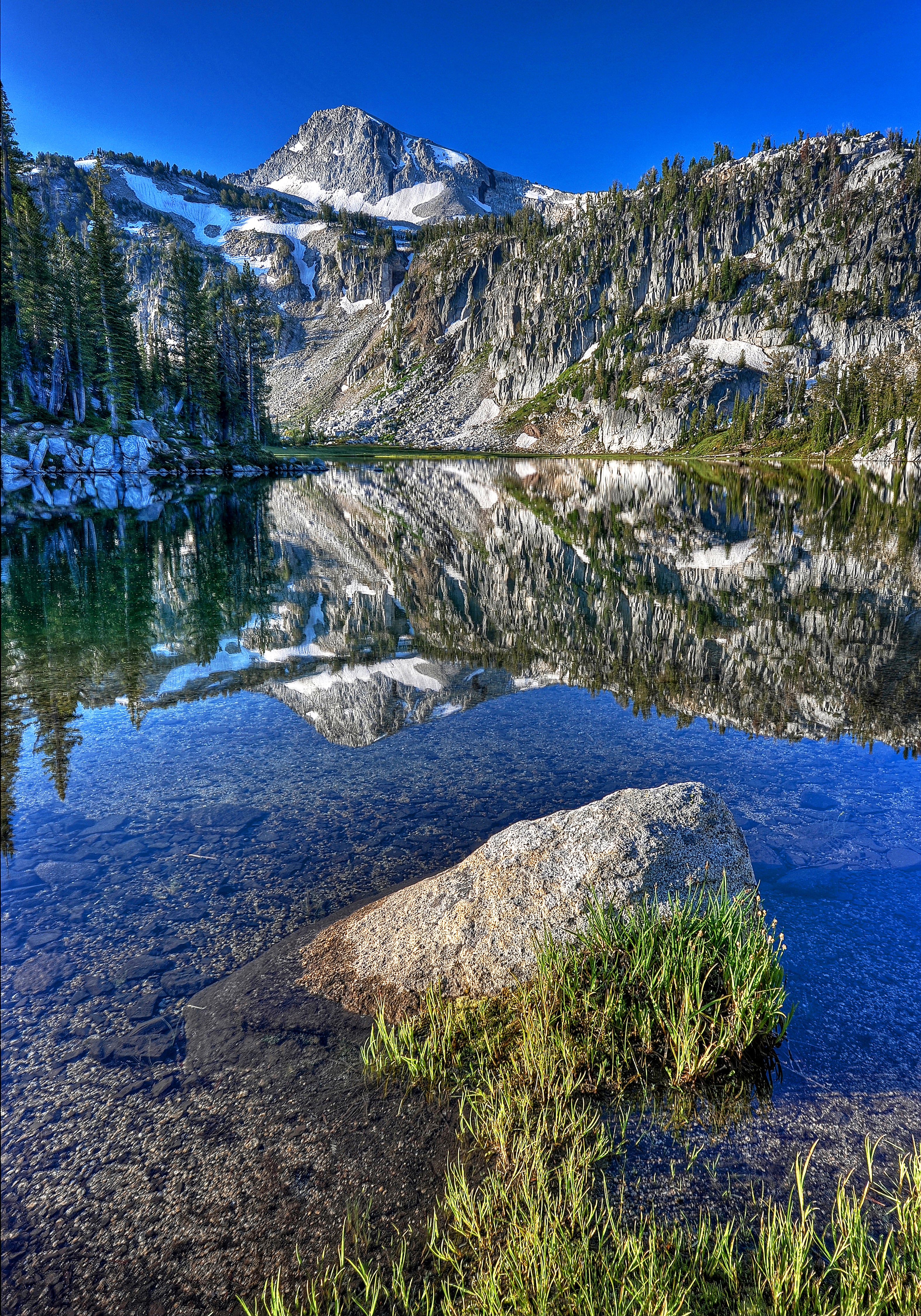 Eagle Cap, the iconic mountain of the Wallowa's Eagle Cap Wilderness, rises above Mirror Lake. Like other peaks in the core of the wilderness, it is composed of granitic rocks that were generated by the heat of the Wallowa Terrane's ancient collision with present-day Idaho on the North American tectonic plate.
