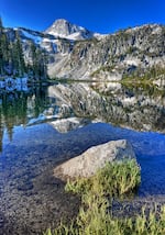 Eagle Cap, the iconic mountain of the Wallowa's Eagle Cap Wilderness, rises above Mirror Lake. Like other peaks in the core of the wilderness, it is composed of granitic rocks that were generated by the heat of the Wallowa Terrane's ancient collision with present-day Idaho on the North American tectonic plate.