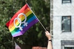 An attendee holds a sign in support of the lesbian community during the Portland Pride Parade Sunday, June 19, 2016.