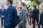 FILE - Meta CEO Mark Zuckerberg passes media and a protester as he arrives for a closed-door gathering of leading tech CEOs to discuss the priorities and risks surrounding artificial intelligence, on Capitol Hill in Washington, on Sept. 13, 2023.