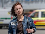 Viktoria Kitsenko poses for a portrait in front of Epicenter, the hardware superstore where she was working when it was hit with a Russian missile, killing 19 people in Kharkiv, Ukraine, on May 26.