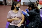 Nicole Fahey, six months pregnant, receives a Pfizer vaccination booster shot from a nurse on Nov. 3, 2021 in Los Angeles, CA.