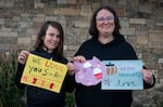 Amy Banton, 37, left, and her son Wallace "Wally" Banton, 10, show the art they made in support of the Silver Rail Elementary community on Oct. 20, 2026 in Bend, Ore. Central Library held a free crafting event and letter writing event.
