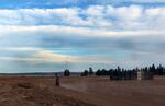 A worker drives off in the direction of the main event area and the Big Summit Prairie.