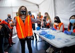 Gov. Kate Brown thanks workers drawing up COVID-19 vaccines as she tours a drive-thru vaccination clinic at Portland International Airport, April 9, 2021. The clinic is a joint operation hosted by Oregon Health & Science University, the Port of Portland and the American Red Cross. 