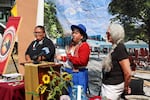 From left: LaDonna Dempsey, Diné; Lluvia Merello, Quechua, Andean/Inca; and Linda Higgins, Yakama Nation, stand outside Project 737, future home of Portland Indigenous Marketplace, during a press conference on August 19, 2026.
