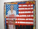 A visitor watches the work of artist Faith Ringgold, "The Flag is Bleeding #2" during a preview on December 4, 2019.