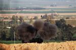 A shock wave is visible as an Israeli army self-propelled artillery fires a round from southern Israel toward the Gaza Strip on Thursday, Feb. 1.