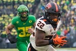 FILE - In this Nov. 30, 2019, file photo, Oregon State Beavers running back Jermar Jefferson (22) runs the ball into the end zone for a touchdown in a game against the Oregon Ducks at Autzen Stadium in Eugene. With Oregon leaving for the Big Ten conference, the future of the OSU-UO rivalry game is unclear.