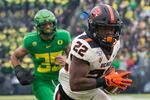 FILE - In this Nov. 30, 2019, file photo, Oregon State Beavers running back Jermar Jefferson (22) runs the ball into the end zone for a touchdown in a game against the Oregon Ducks at Autzen Stadium in Eugene. With Oregon leaving for the Big Ten conference, the future of the OSU-UO rivalry game is unclear.