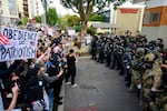 Federal agents confront protesters outside of the U.S. Immigration and Customs Enforcement building on September 28, 2025 in Portland, Oregon.