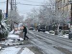 The streets of Portland were relatively quite Tuesday morning after the city received two inches of snow. A shopkeeper along Southeast Division Street in Portland worked to clear parking areas on Dec. 28, 2021.