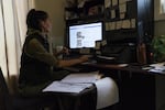 Tatiana Resetnikov scrolls through news feeds about Douglas County's Second Amendment Preservation Ordinance in her home on Oct. 25, 2018 in Winchester Bay, Oregon. Resetnikov is an activist organizing opposition to the ordinance which she says gives too much power to he sheriff.