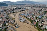 In this aerial image of the Kathmandu valley, Bagmati River is seen flooded due to heavy rains in Kathmandu, Nepal, Saturday, Sept. 28, 2024. (AP Photo/Gopen Rai)