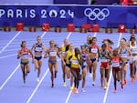 Runners compete during a heat in the women's 5000-meter run at the 2024 Summer Olympics, Friday, in Saint-Denis, France. 