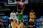 Oregon forward Eric Williams Jr. (50) dunks against Iowa during the first half of a men's college basketball game in the second round of the NCAA tournament at Bankers Life Fieldhouse in Indianapolis, Monday, March 22, 2021.