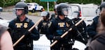 Federal law enforcement officers hold a police line at the Portland ICE building on SW Macadam Avenue Thursday, June 28, 2018, after officials worked to clear the entrance to the building.