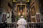 Pope Francis prays in San Marcello al Corso church in Rome on March 15, 2020.