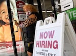 A 'now hiring' sign is displayed outside of a Burlington Coat Factory retail store in downtown Los Angeles on March 11.