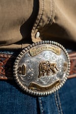 Cole shows his championship belt buckle won at last year's Round-Up.