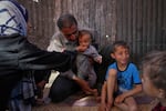 Wedad Abdelaal and her husband Ammar feed their 9-month-old son Khaled, in their tent at a camp for displaced Palestinians in Mawasi Khan Younis, Gaza Strip on Friday.