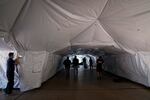 Engineers and volunteers help build a mobile field hospital at UCI Medical Center, Monday, Dec. 21, 2020, in Orange, Calif.