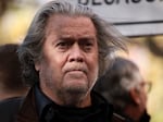 Former Trump administration White House adviser Steve Bannon listens as attorney David Schoen speaks to reporters outside of the E. Barrett Prettyman Federal District Court House on Nov. 15, 2021.