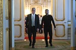 Britain's Prime Minister Keir Starmer (L) and Ukraine's President Volodymyr Zelensky (R) head to a private room to hold a meeting during a summit at Lancaster House on March 2 in London, England.