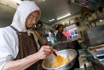 Frybaby owner Sunny Hatch prepares an order of mac & cheese, Korean-American style, in Southeast Portland, April 6, 2023. The food cart was recognized by Eater Portland in its 2023 awards. 