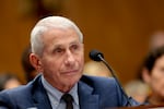 Anthony Fauci sits in front of a microphone as he listens during a hearing with the Senate Homeland Security and Governmental Affairs Committee on July 29.