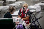 Emily Girard of the American Red Cross speaks with Sue Barnes at an American Red Cross shelter at the Oregon Convention Center in Portland, Ore., on Monday, Sept. 14, 2020, after Barnes evacuated because of wildfires burning throughout the region.