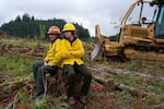 From left, Oregon Department of Forestry Sweet Home unit administrator and dispatcher Niki Stafford and her daughter, Jillian Stafford, 16, sit on a stump together during the training. Jillian Stafford hopes to work in wildland firefighting when she’s old enough.