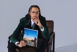 In this provided photo, taken January 9, 2026, Lakayana Yotoma Drury is pictured holding his new, magazine-style "503" collection of essays, photos, poems called "503."