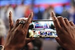 A delegate takes a photo at the Democratic National Convention in Philadelphia.