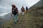 Villagers Said Baltistani, Yasin Malik and NPR translator Zeba Batool hike up a mountain looming over the village of Chunda to inspect the glacier baby.