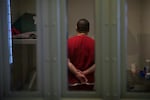 FILE - A detainee stands in a cell in the segregation area of the Northwest ICE Processing Center on Wednesday, June 21, 2017, in Tacoma.