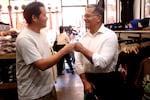 Xavier Becerra is shown fist-bumping a man during a campaign stop.