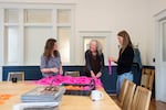 From left, Sellwood Community House volunteer coordinator Allison Eshel and volunteers Susie Hart-Walker and Lucy Yeo work on decorations for their “Neighborhood Possibility” fundraiser in Portland, Ore., on May 15, 2026. The former public community center that nearly closed in 2019 is now run by the Sellwood Community House nonprofit.