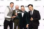Four men stand together smiling at the backstage of 2026 James Beard Awards after winning an award.